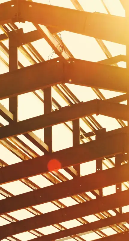 Background image of a steel building frame